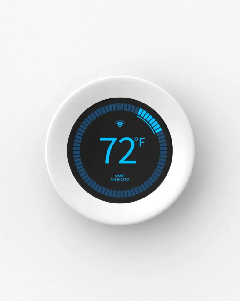 Smart thermostat displaying 72°F on a digital screen, mounted on a white wall.