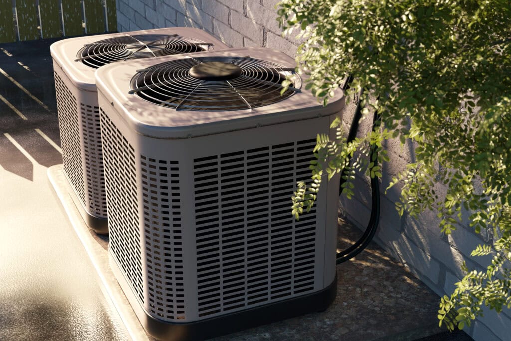 Two outdoor air conditioning units sit on a concrete platform next to a brick wall, partially shaded by tree branches—a testament to quality HVAC Services Norwalk CT & White Plains NY residents rely on.